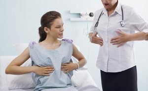 How can I self-examine my breasts?